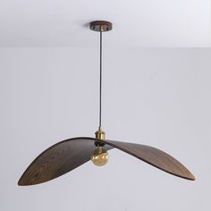 a ceiling fan hanging from the ceiling in a room with white walls and flooring