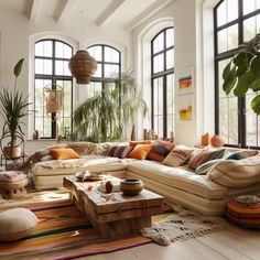 a living room filled with furniture and lots of windows