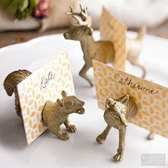 three little deer figurines sitting on top of a white plate next to each other