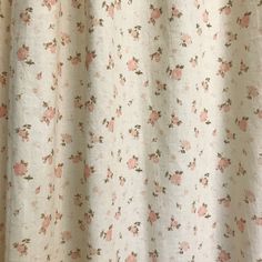 a white curtain with pink flowers on it