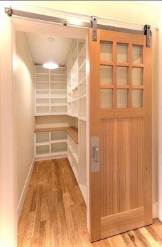 an empty walk in closet with wooden doors