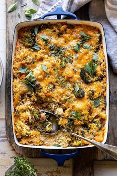 a casserole dish with broccoli, cheese and other vegetables in it