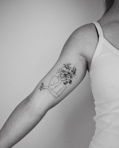 a woman with a flower tattoo on her arm