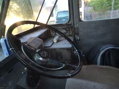 the interior of an old truck with a steering wheel