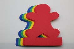 a paper cut out of the shape of a person with a rainbow on it's side