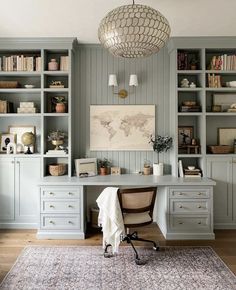 a home office with built in bookcases and a rug on the floor