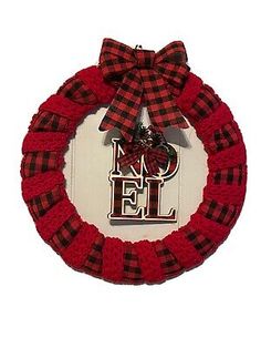 a red and black wreath with the word noel on it