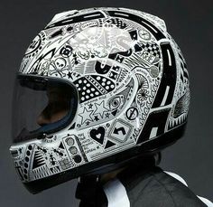 a person wearing a motorcycle helmet with designs on it