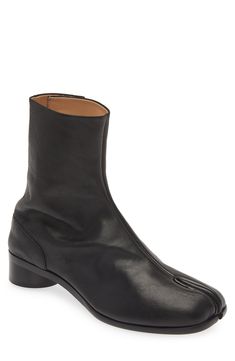 Inspired by the Japanese tabi sock, this iconic split-toe boot is crafted from supple Italian leather and set on a cylindrical heel. Hook closure Leather upper, lining and sole Made in Italy Designer Shoes Tabi Boots Men, Split Toe Boots, Boots Outfit Men, Black Boots Men, Tabi Boots, Maison Margiela Tabi, Margiela Tabi, Platform Slippers, Mens Eyewear