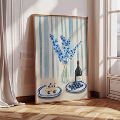 a painting with blue flowers in a vase next to a plate and bottle on a table