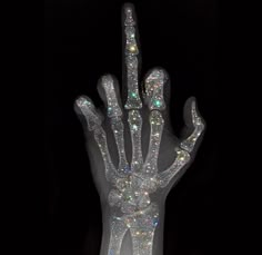 a hand made out of crystal stones in the dark