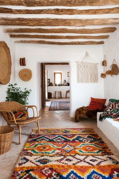 a living room filled with lots of furniture next to a wall covered in wicker baskets