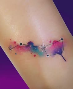 a small tattoo with stars on the side of its arm and behind it is an arrow