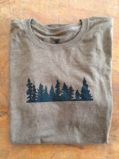 a t - shirt that has trees on it