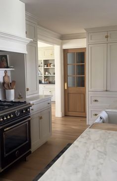 a kitchen with white cabinets and an oven