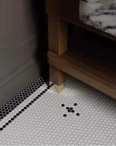 a bathroom floor with black and white dots on it