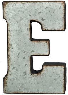 an old rusty metal letter e on a white background