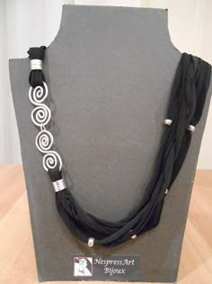 a black and white necklace with silver beads