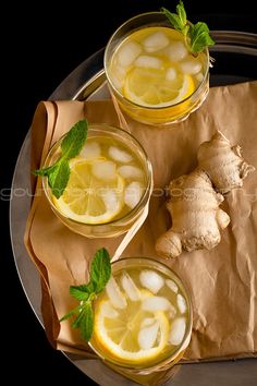 two glasses filled with ice and lemon slices