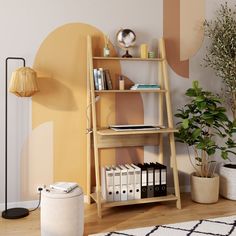 a living room with a book shelf, potted plant and books on the floor