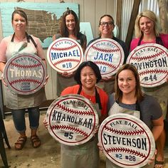 the women are holding up their personalized baseball signs for everyone to know about them