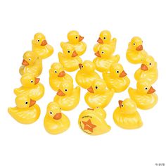 yellow rubber ducks are lined up on a white background