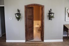 an open door leading into a room with two lamps on either side of the doorway