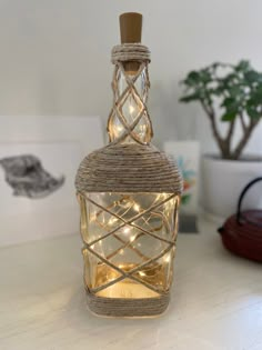 a glass bottle with lights inside on a table