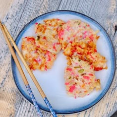 two chopsticks are sitting on a plate with food