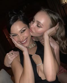 two beautiful young women hugging each other