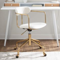 a white desk with a gold metal chair in front of it and a mirror on the wall