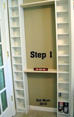 a white book shelf sitting in the corner of a room