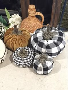 several decorative pumpkins are sitting on the ground