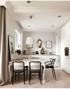 a dining room table and chairs in front of an oven