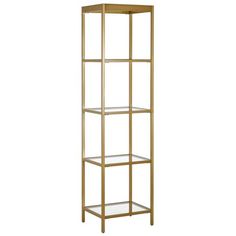 a tall gold metal shelf with glass shelves