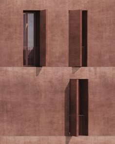 three windows on the side of a building