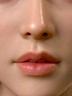 a close up shot of a woman's face with her eyes closed and nose slightly open