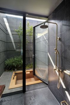 a walk in shower sitting inside of a bathroom next to a wooden bench and window