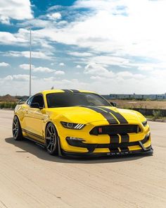 a yellow car with black stripes on it