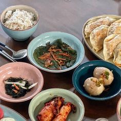 a table topped with bowls filled with different types of food