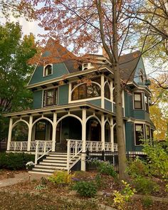 a large green house sitting next to a tree