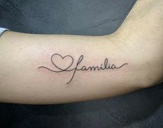 a tattoo with the word family written in cursive writing on it's arm