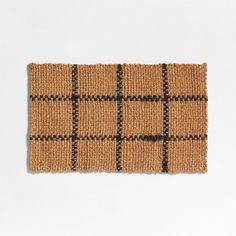 a brown and black checkered door mat on a white surface with the words,