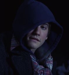 a person wearing a hoodie in the dark