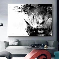 a living room filled with furniture and a painting on the wall over a coffee table