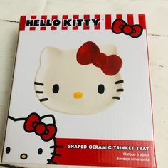 hello kitty shaped ceramic trinket tray with red bow on the top and bottom