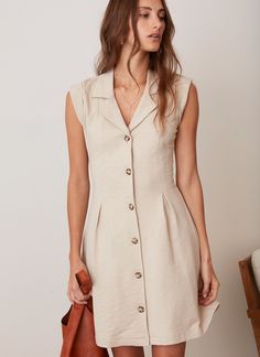 In a league of her own. The Joan Dress invites you to wander sun-drenched streets with its effortless charm. Featuring roll-tab sleeves, elasticated back waist detail and a figure flattering fit and flare silhouette. It is perfect for the modern explorer seeking chic simplicity. V Neck Cotton Dress, Vintage Casual Dress, Supportive Dresses, Classic Sundress, Paris Summer Outfits, Summer Office Dress, Feminine Summer Outfits, Ikkat Dresses, Dramatic Classic