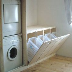 a washer and dryer are in the corner of a room next to a window