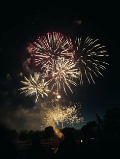 fireworks are lit up in the night sky