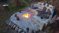 an outdoor fire pit with chairs around it